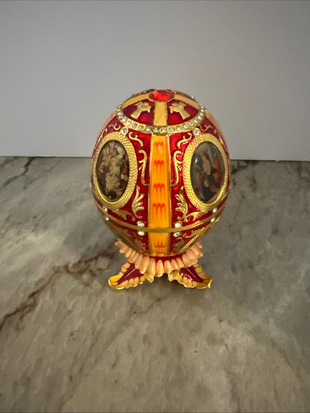 Red and Gold Decorative FabergΓ©-Style Egg Ornament Nativity scene inside. Read .